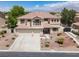 Two-story home with a tile roof, three-car garage, and well-maintained landscaping at 7310 Heggie Ave, Las Vegas, NV 89131