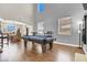 Spacious game room with a pool table and hardwood floors, perfect for entertaining guests at 7310 Heggie Ave, Las Vegas, NV 89131