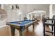Large game room showcasing a pool table, hardwood floors, and access to the dining area at 7310 Heggie Ave, Las Vegas, NV 89131