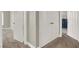 Hallway featuring multiple doors and neutral colored carpet and walls at 7310 Heggie Ave, Las Vegas, NV 89131