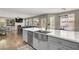 Open floorplan kitchen features grey cabinetry and large island with view to the living room at 7310 Heggie Ave, Las Vegas, NV 89131
