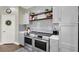 Modern kitchen with stainless steel oven and grey cabinets and a subway tile backsplash at 7310 Heggie Ave, Las Vegas, NV 89131
