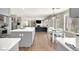 Open-concept kitchen with a large island, stainless steel appliances, and dining area at 7310 Heggie Ave, Las Vegas, NV 89131