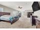 Large primary bedroom featuring a fireplace, lounge chair, and ceiling fan at 7310 Heggie Ave, Las Vegas, NV 89131