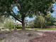 Scenic view of a park featuring a gazebo, picnic tables, lush greenery, and mature trees at 7310 Heggie Ave, Las Vegas, NV 89131