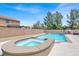 Backyard pool and spa are surrounded by concrete decking and block wall at 7310 Heggie Ave, Las Vegas, NV 89131