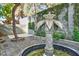Backyard area features an ornate fountain with stone work and mature landscaping at 7429 Fencerow St, Las Vegas, NV 89131