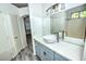 Bathroom vanity featuring a vessel sink, granite countertop, and wood-look flooring at 7429 Fencerow St, Las Vegas, NV 89131