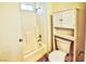 Bright bathroom featuring a shower-tub combo, classic fixtures, and a white cabinet unit above the toilet at 7429 Fencerow St, Las Vegas, NV 89131