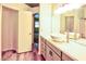 Bright bathroom featuring vessel sinks, modern vanity, and wood look floors for a sleek, contemporary feel at 7429 Fencerow St, Las Vegas, NV 89131
