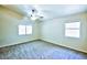 A serene bedroom enhanced by natural light from two windows and a modern ceiling fan at 7429 Fencerow St, Las Vegas, NV 89131