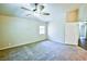 This carpeted bedroom features a ceiling fan and a window letting in natural light at 7429 Fencerow St, Las Vegas, NV 89131