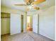 A bedroom with a closet, neutral carpet, and a ceiling fan offers a calm and inviting atmosphere at 7429 Fencerow St, Las Vegas, NV 89131