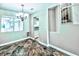 Charming dining room with unique tile flooring, modern chandelier, and bright natural light at 7429 Fencerow St, Las Vegas, NV 89131