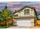 Lovely two-story home with a two-car garage, manicured lawn, and brick-lined driveway at 7429 Fencerow St, Las Vegas, NV 89131
