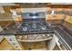 Stainless steel gas range oven in updated kitchen with stone floors and decorative backsplash at 7429 Fencerow St, Las Vegas, NV 89131