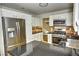 Well-equipped kitchen featuring stainless steel appliances, granite countertops and stone floors at 7429 Fencerow St, Las Vegas, NV 89131