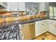 Gourmet kitchen boasts stainless steel appliances, granite countertops, and decorative backsplash at 7429 Fencerow St, Las Vegas, NV 89131