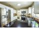 Modern kitchen featuring stainless steel refrigerator, granite countertops, and white cabinets at 7429 Fencerow St, Las Vegas, NV 89131