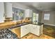Modern kitchen features white cabinets, stainless steel appliances, and stone floors at 7429 Fencerow St, Las Vegas, NV 89131