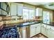 Updated kitchen featuring stainless steel appliances, granite countertops, and plenty of natural light at 7429 Fencerow St, Las Vegas, NV 89131