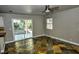 Cozy living room with backyard access through sliding glass doors, beautiful stone floors at 7429 Fencerow St, Las Vegas, NV 89131