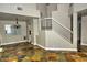 Open floor plan with stone floors and white staircase railing enhance the living space at 7429 Fencerow St, Las Vegas, NV 89131