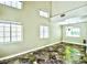 Spacious living room featuring high ceilings, ample natural light, and distinctive tile flooring at 7429 Fencerow St, Las Vegas, NV 89131