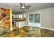 Open-concept living room with tile floors and access to the backyard through sliding glass doors at 7429 Fencerow St, Las Vegas, NV 89131