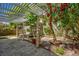 Backyard patio includes white cover, lush greenery, and a fountain for a relaxed, inviting atmosphere at 7429 Fencerow St, Las Vegas, NV 89131