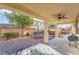 Relaxing covered back patio featuring ceiling fan and ample outdoor seating area at 7778 Villa Montara St, Las Vegas, NV 89123