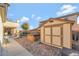 This serene backyard features a shed and a luxurious hot tub for relaxation at 7778 Villa Montara St, Las Vegas, NV 89123