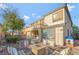 A luxurious backyard space, complete with a fire pit, dining set, BBQ, and multi-story home at 7778 Villa Montara St, Las Vegas, NV 89123