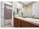 Bathroom featuring double sinks, wooden cabinets, and a separate toilet and shower room at 7778 Villa Montara St, Las Vegas, NV 89123