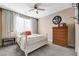 Comfortable bedroom with a ceiling fan, neutral tones, and natural light at 7778 Villa Montara St, Las Vegas, NV 89123