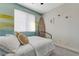 Bright bedroom with white bedding and a surfboard decor at 7778 Villa Montara St, Las Vegas, NV 89123