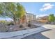 Charming two-story home with stone accents, three-car garage, and landscaped front yard at 7778 Villa Montara St, Las Vegas, NV 89123