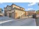 View of the house with a three-car garage and backyard featuring a gated entrance at 7778 Villa Montara St, Las Vegas, NV 89123