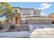 Inviting two-story home featuring a stone-accented facade and a spacious three-car garage at 7778 Villa Montara St, Las Vegas, NV 89123