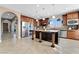 Bright, open kitchen with a large island, stainless steel appliances, and wood cabinetry at 7778 Villa Montara St, Las Vegas, NV 89123