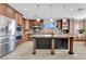 Spacious kitchen featuring a central island, stainless steel appliances, and warm wood cabinetry at 7778 Villa Montara St, Las Vegas, NV 89123