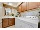 Convenient laundry room equipped with washer, dryer, sink, and ample cabinet space at 7778 Villa Montara St, Las Vegas, NV 89123
