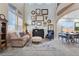 Bright living room featuring a grand piano, comfortable seating, and picture windows at 7778 Villa Montara St, Las Vegas, NV 89123