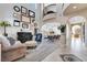 Bright living room featuring a grand piano, comfortable seating, and arched doorways at 7778 Villa Montara St, Las Vegas, NV 89123