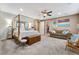 Spacious main bedroom with a canopy bed, sofa, and artwork at 7778 Villa Montara St, Las Vegas, NV 89123