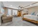 Spacious main bedroom with a canopy bed, sitting area, and walk-in closet at 7778 Villa Montara St, Las Vegas, NV 89123