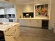 Bright kitchen featuring quartz countertops, white cabinets, modern artwork, and a wine fridge at 8255 Las Vegas Blvd # 611, Las Vegas, NV 89123
