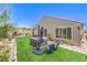 Lush backyard with a hot tub, outdoor seating, and manicured landscaping, ideal for relaxation at 8269 Skye Peak St, Las Vegas, NV 89166