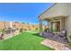 Backyard featuring a covered patio, outdoor seating, putting green, and desert landscaping at 8269 Skye Peak St, Las Vegas, NV 89166