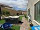 Charming backyard with a hot tub, seating area, and lush landscaping at 8269 Skye Peak St, Las Vegas, NV 89166